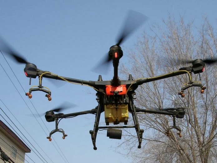 Agricultural spray drone over a field